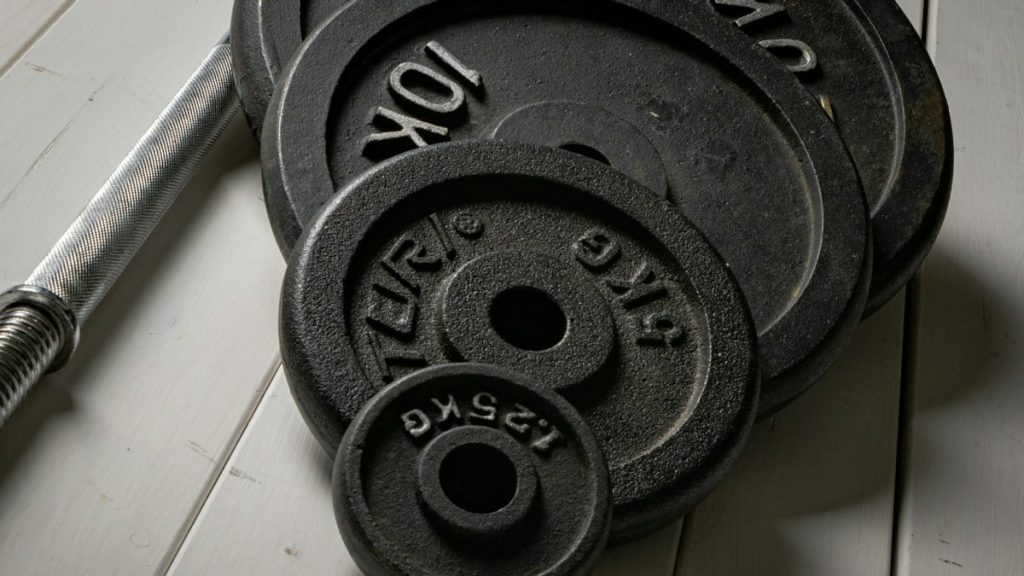 Weight plates and barbell setup for strength training at home. Fitness gear I would use → linktr.ee/alexsaks.inspiration